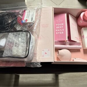 A set of June & Olive do it yourself nail kit & a dipping powder nail kit.